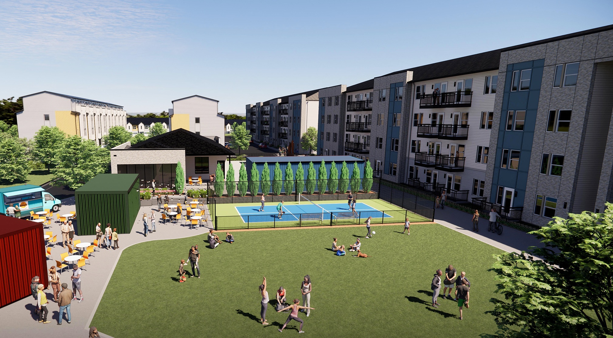 an aerial view of an apartment complex with people playing on a lawn